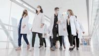 Dermatology faculty and residents walking down a hallway